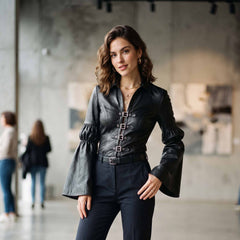 Front view of elegant woman wearing fitted black leather poet blouse with flared bell sleeves and front buckle straps in art gallery