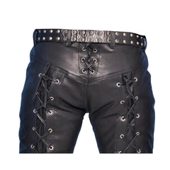 Black leather pants with lace-up side details, a studded belt, and silver metal eyelets, shown on a white background.