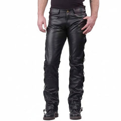 Black leather motorcycle chaps with a skull and 'Real Leather' logo patch on the lower left leg, shown on a model against a white background.