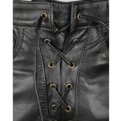 Close-up of a black leather garment with a lace-up front, showing the stitching, eyelets, and laces. A Leather Addict logo is visible in the top-left corner.