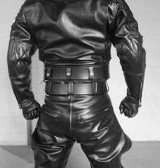A black leather body armor suit shown from the back, featuring padded shoulder sections, a wide belt with multiple straps, and integrated gloves, photographed against a plain light background.